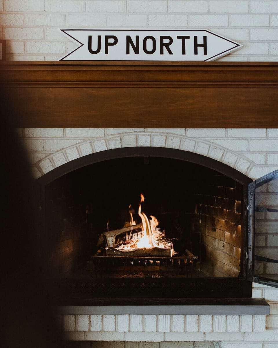 Two wood burning fireplaces with firewood