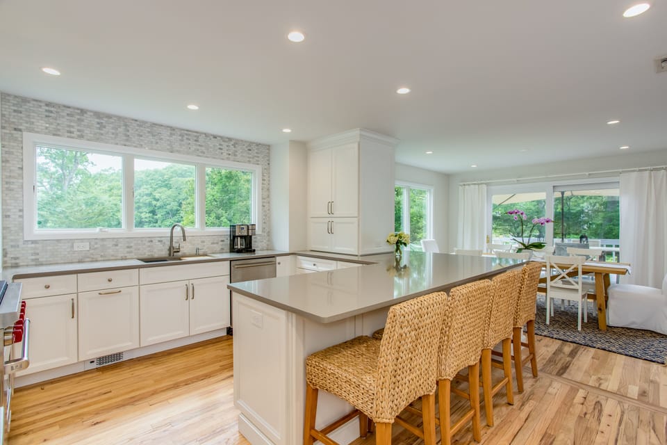 Kitchen with eat-in counter, serving area and view of Long Creek from sink