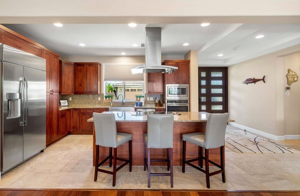 The fully-stocked kitchen has breakfast bar for three.