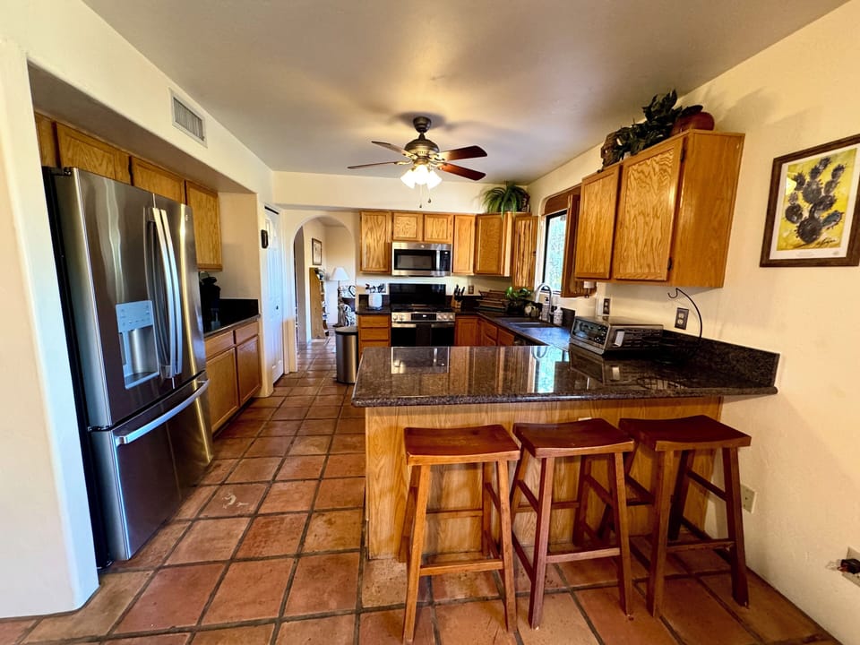 Well stocked kitchen, updated appliances, coffee station and breakfast bar