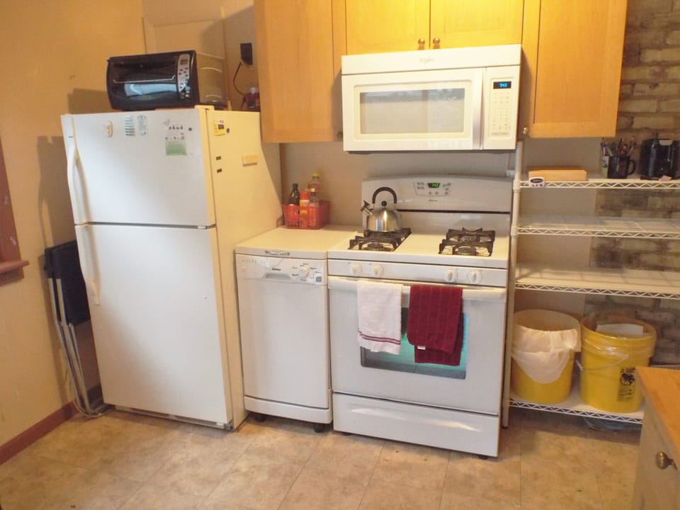 Fully equipped kitchen: stove, fridge, dishwasher, dishes, coffee maker, & more.