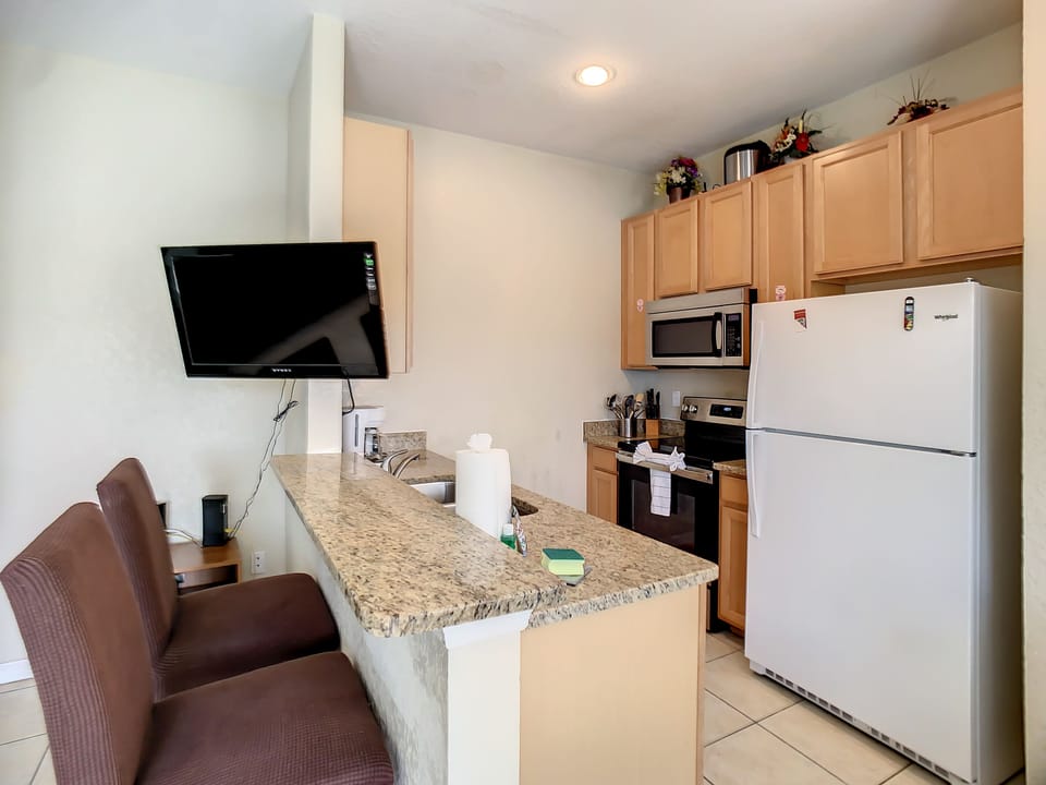 Fully Equipped Kitchen with bar chairs