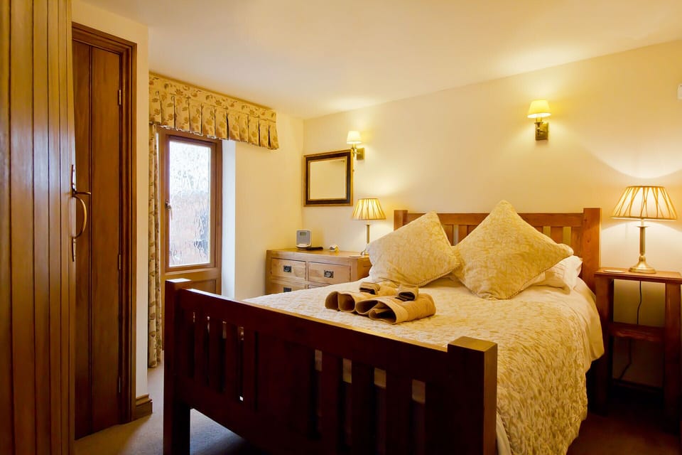 Downstairs bedroom with oak double beds and its own television.