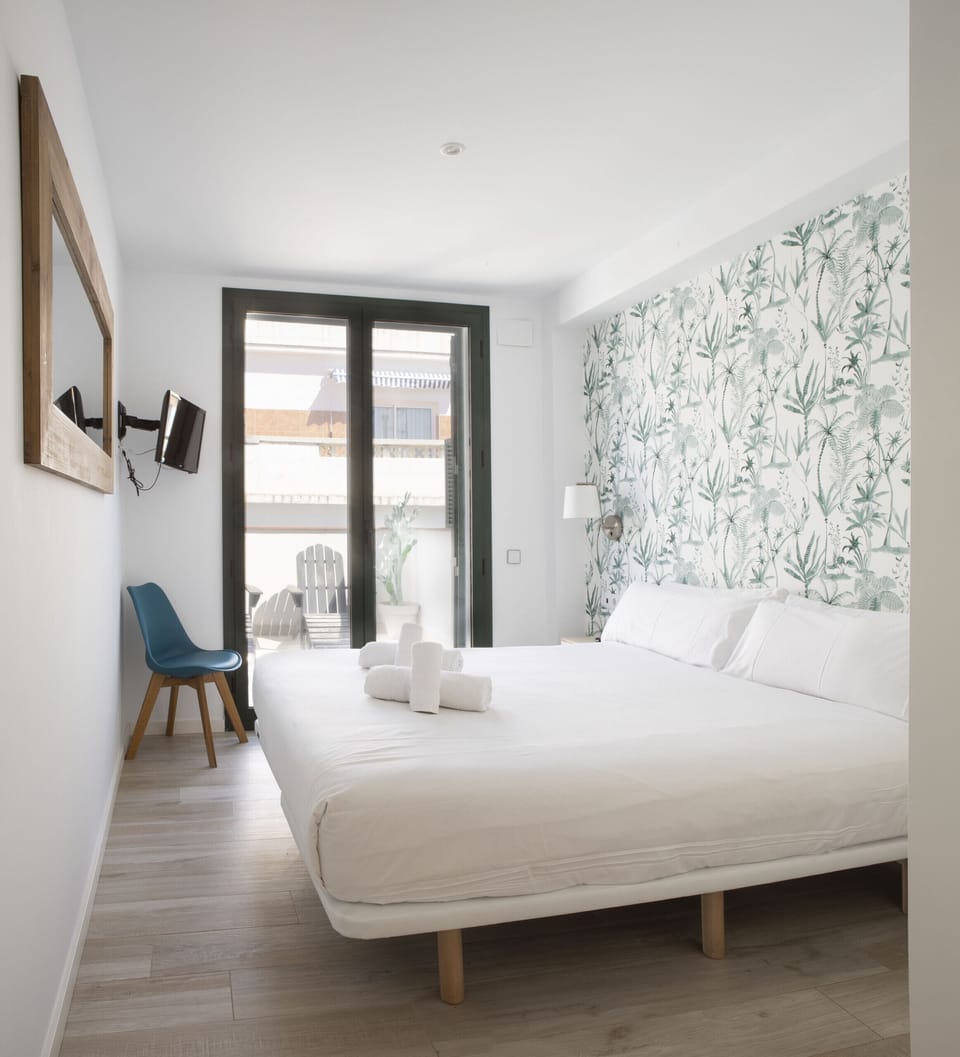 Bedroom of the Urban Suites Sitges Terrace holiday apartment, with a double bed and access to the terrace