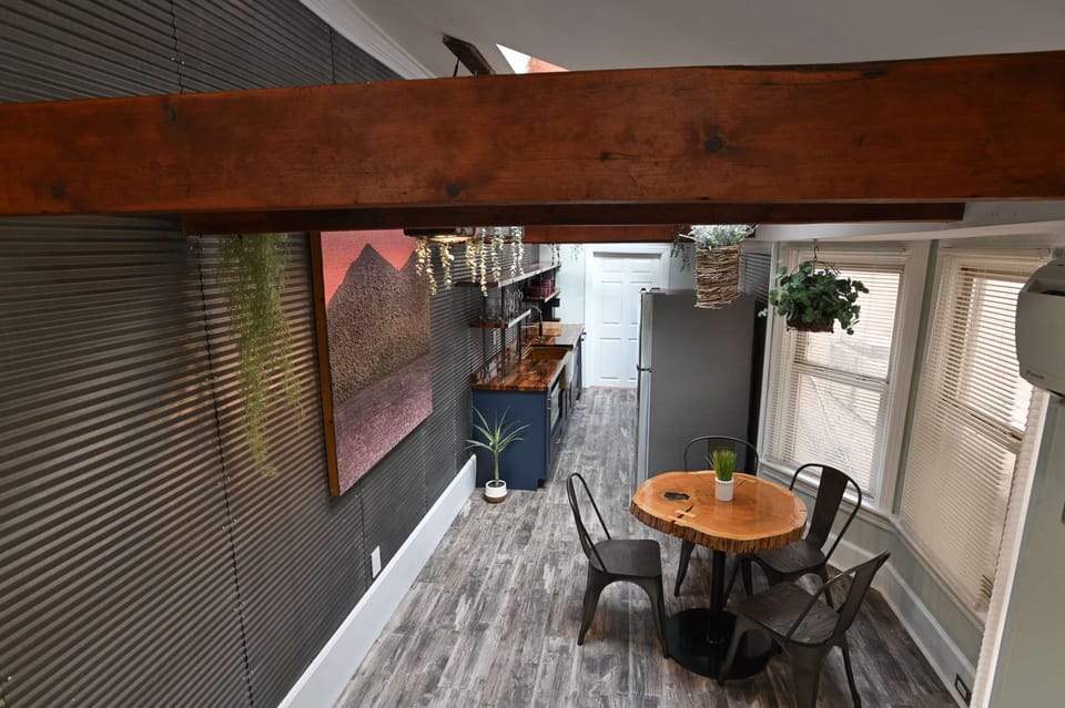 Bright dining area w/ round table, stylish chairs &amp; easy access to the outdoor patio