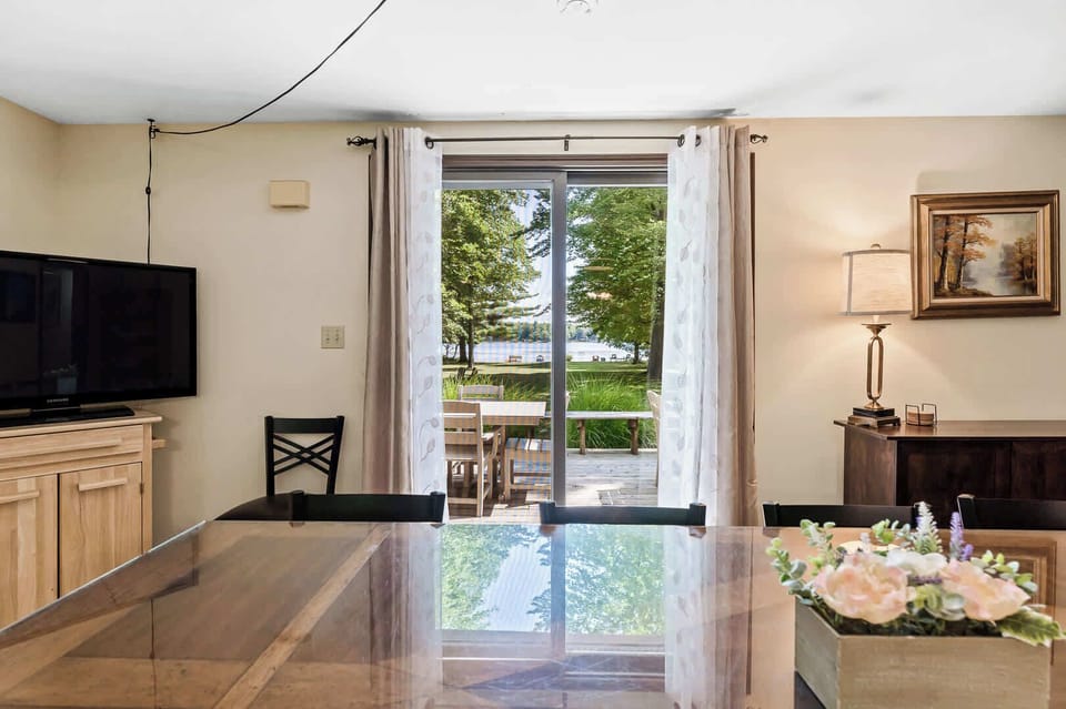 Enjoy our newly-upgraded dining room with LVT flooring and two sliding glass doors leading onto the lake-facing deck (new 2nd sliding glass door lies just to the right). This newly brightened space next to the kitchen is perfect for family meals.