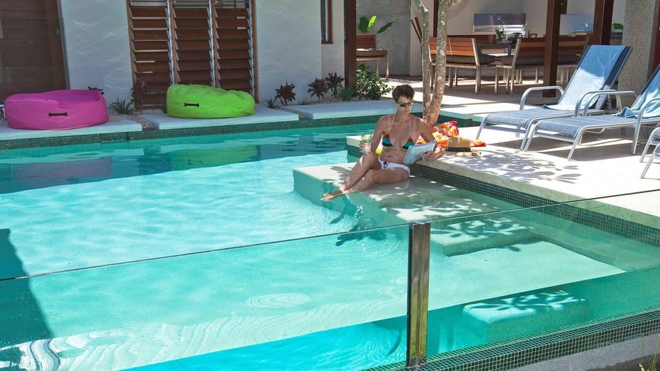 Fully glass fence  surrounds the pool