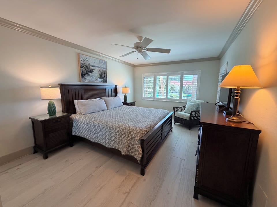 Sink into your plush bed after a day of exploring, with a gentle ceiling fan keeping you cool and crown molding adding a touch of elegance overhead.