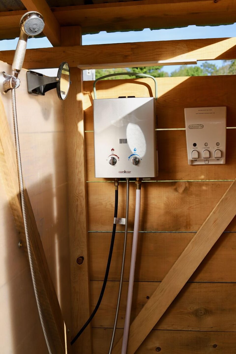 Hot water outdoor shower with soap, conditioner, and shampoo