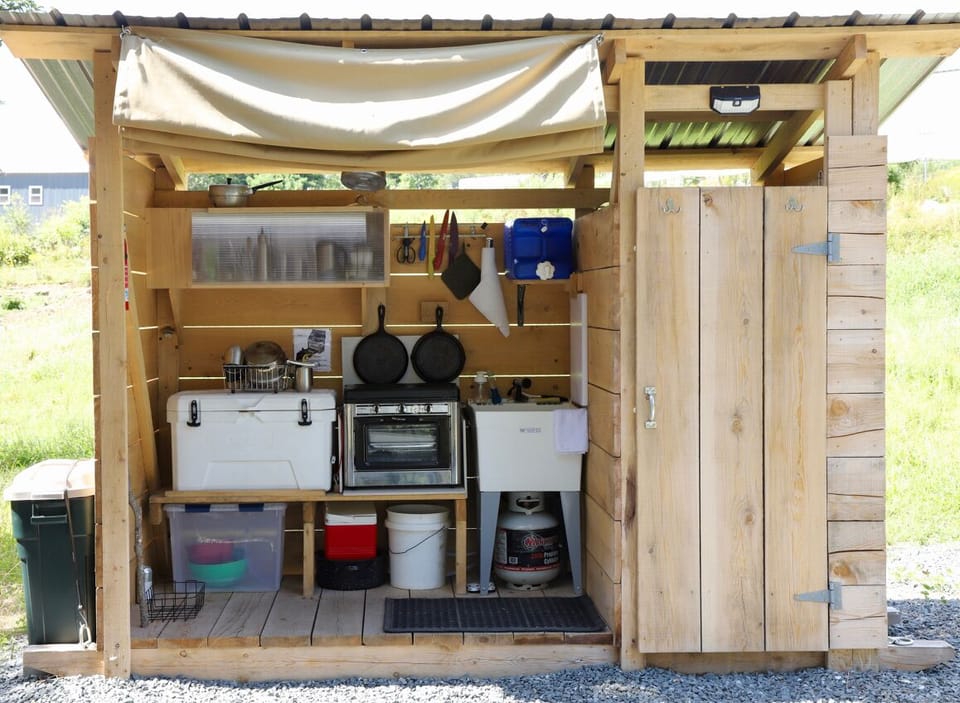 Fully stocked outdoor kitchen and shower.
