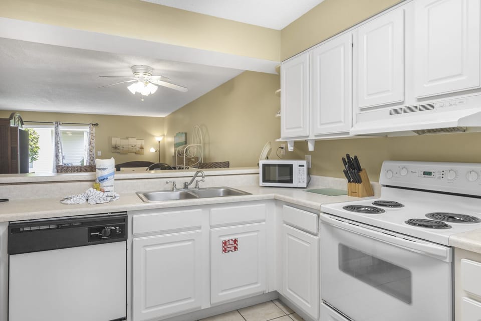A bright white kitchen with everything you need to cook in.