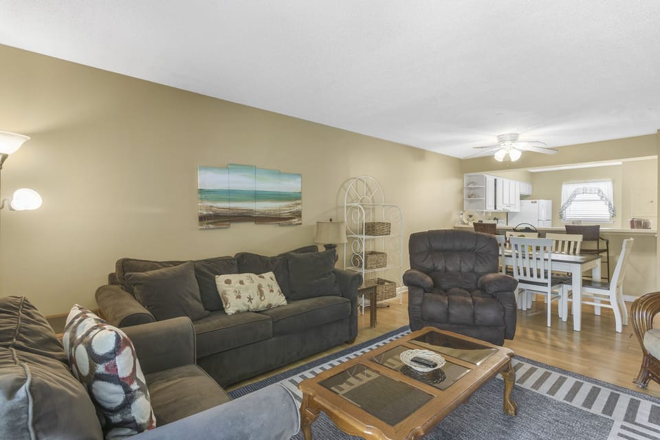 Sink into the sofas beneath cheerful beach art.
