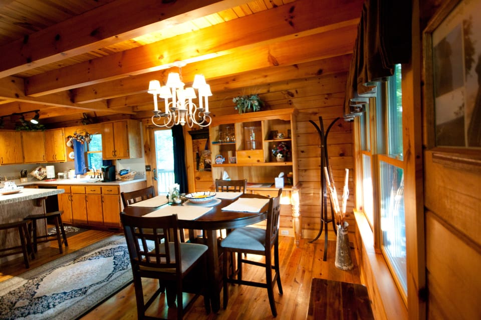 Kitchen/dining area has exposed ceiling beams for that cozy rustic cabin feel