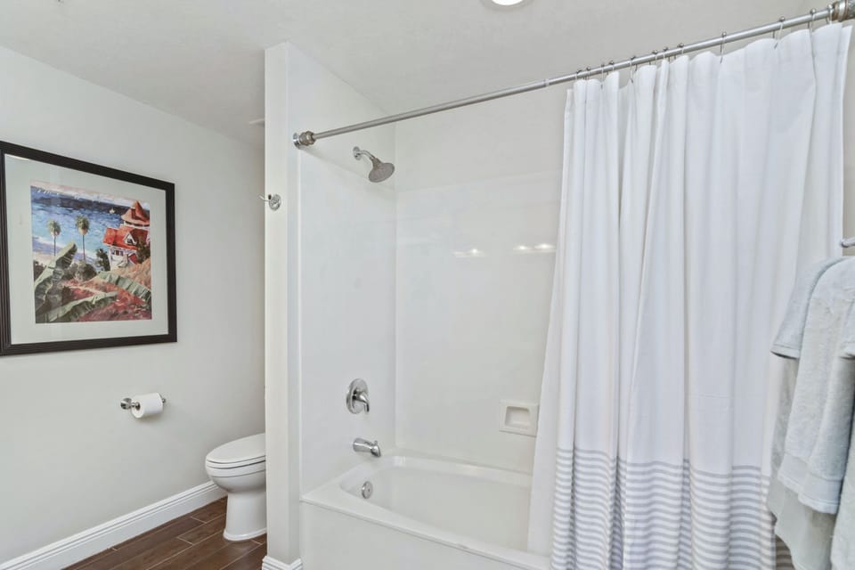 Tub shower combo in master bath.