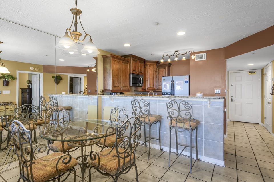 Granite bar seating and a dining space for shared meals.