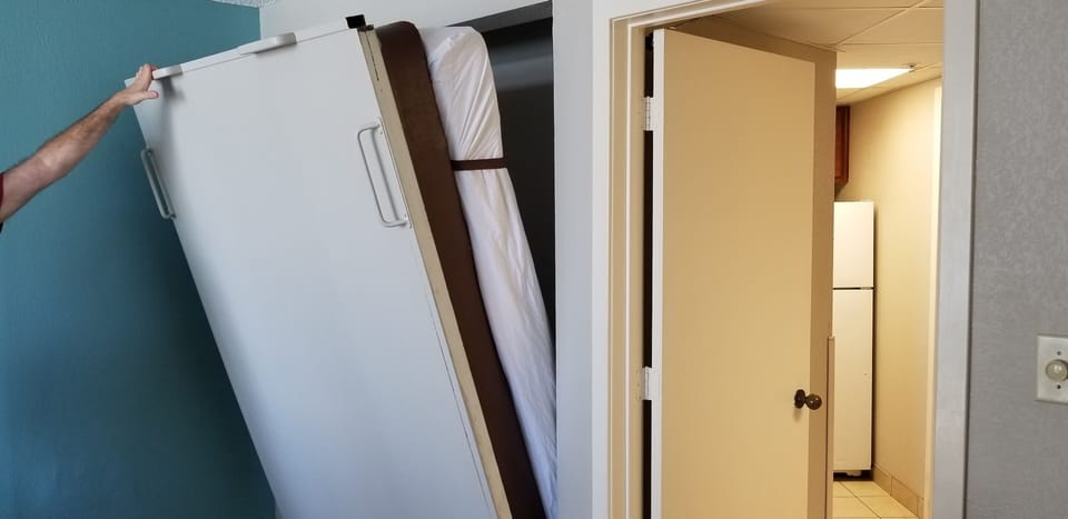 The Murphy bed being pulled out.