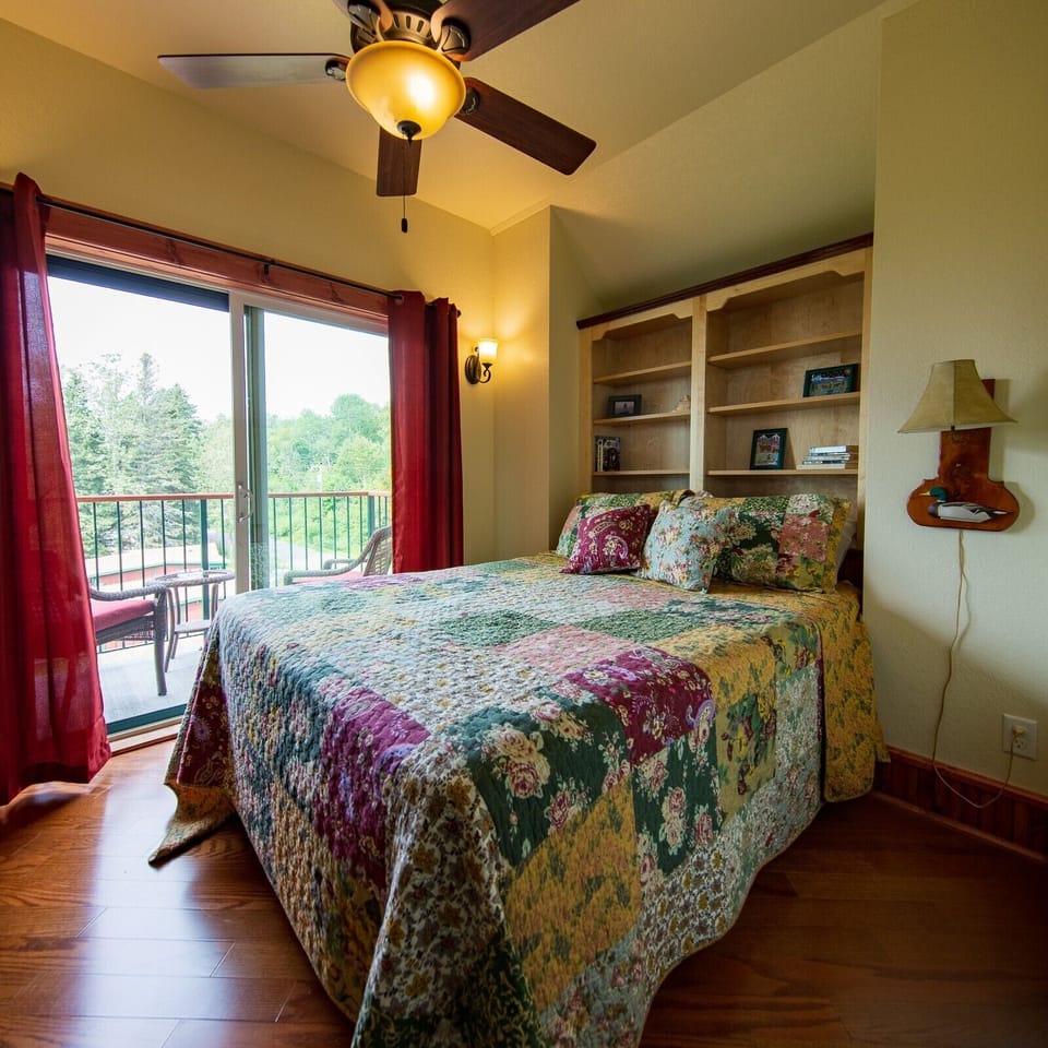 Bedroom
How can it get better than this. Imagine laying on the plush queen bed reading a good book within the glow of the gas stove. As you look out to the balcony you have views of Lake Superior from Inn Suite #8.