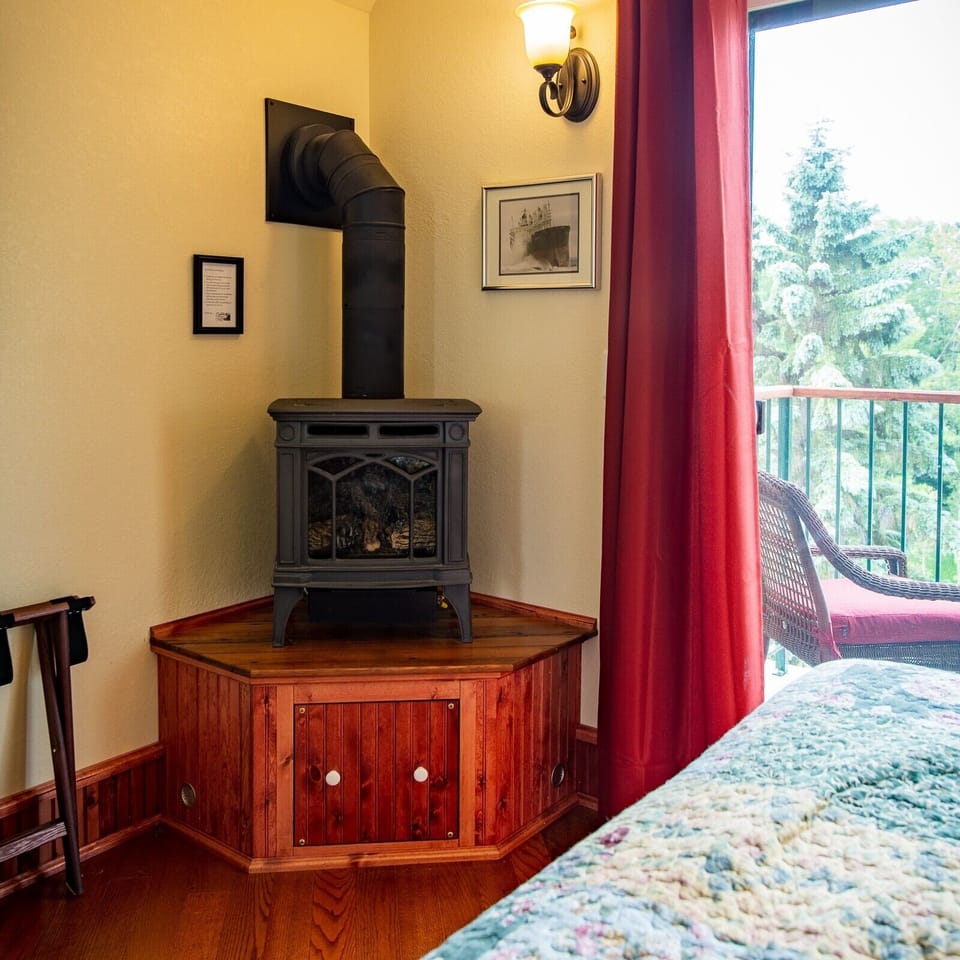 Bedroom With Gas Stove
The bedroom in Inn Suite #8 is complete with a romantic gas stove and its flames and embers to keep you warm on the North Shore.