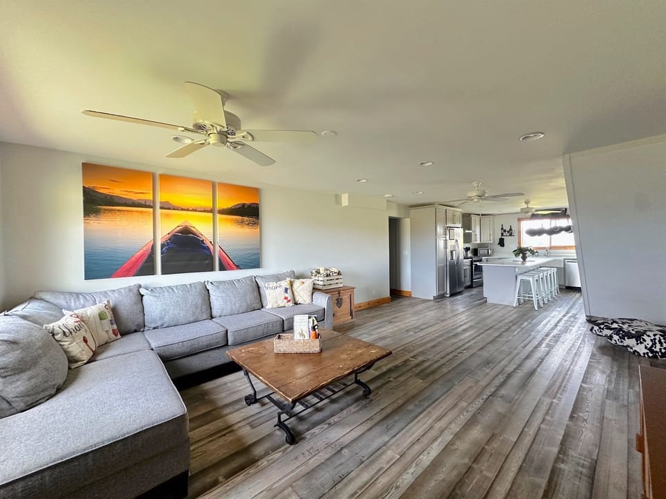 The living room provides a large, comfortable sofa for lounging.