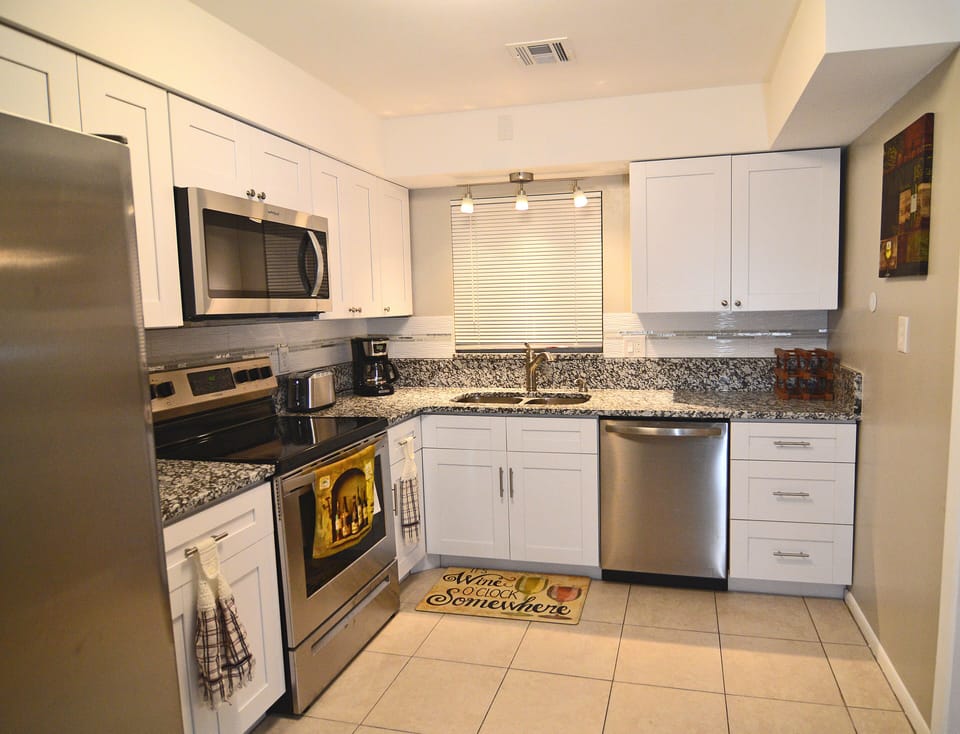 Granite and new cabinets with stainless steel appliances. 