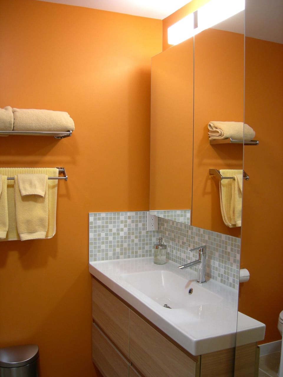 1st floor guest bathroom with retro glass tile backsplash.
