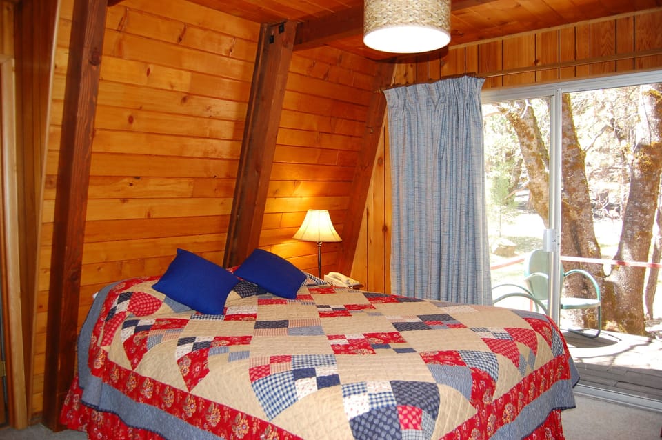 Bedroom 1 with queen bed and sliding glass doors to deck