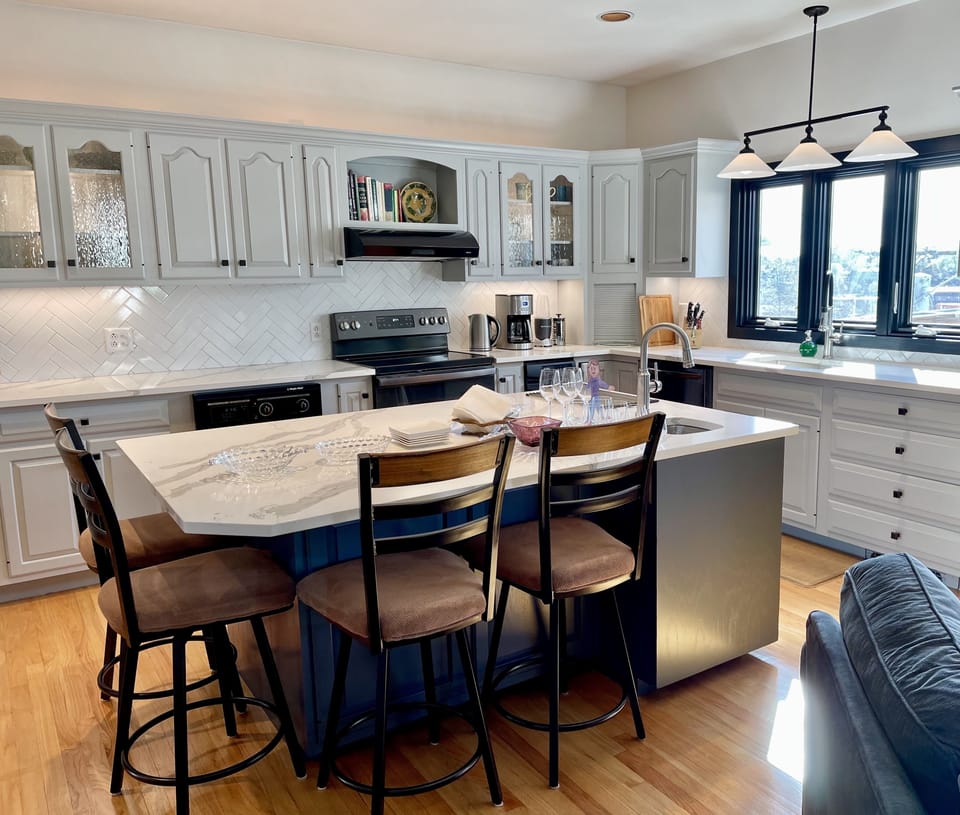 Kitchen Island seats 4. Adjacent dining room seats 6.