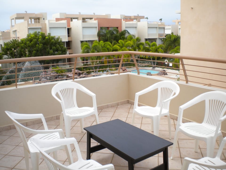 Balcony off living areas overlooking swimming pool