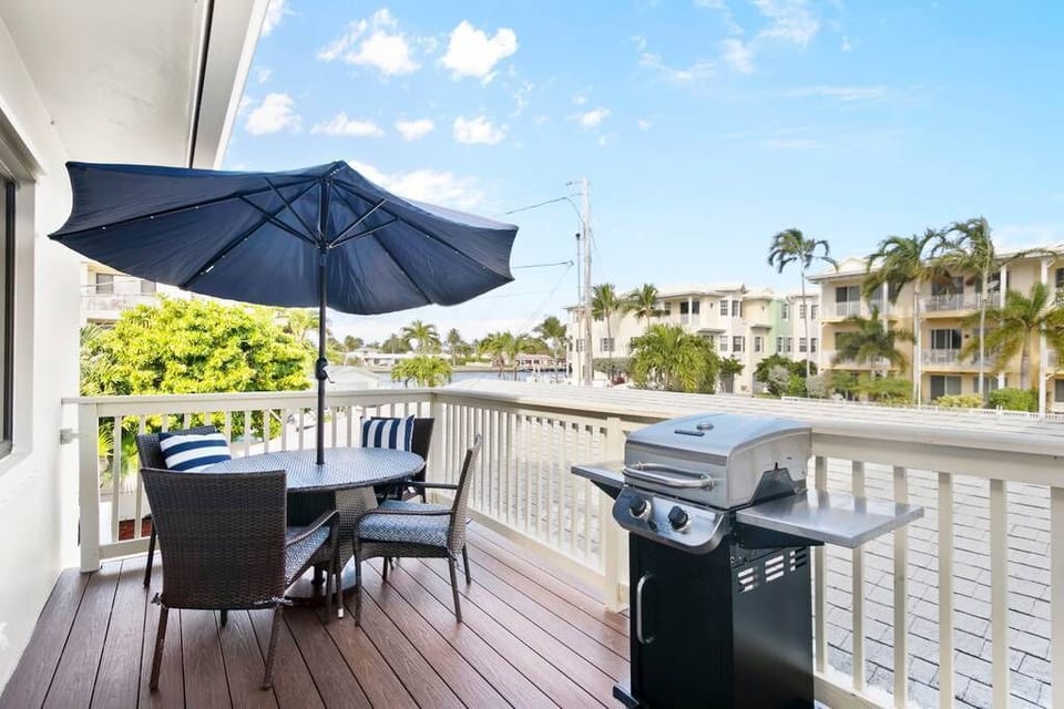 Private balcony overlooking a serene waterfront canal.