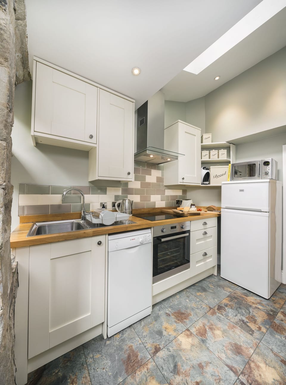 The roof light and fully equipped kitchen makes cooking here a pleasure.