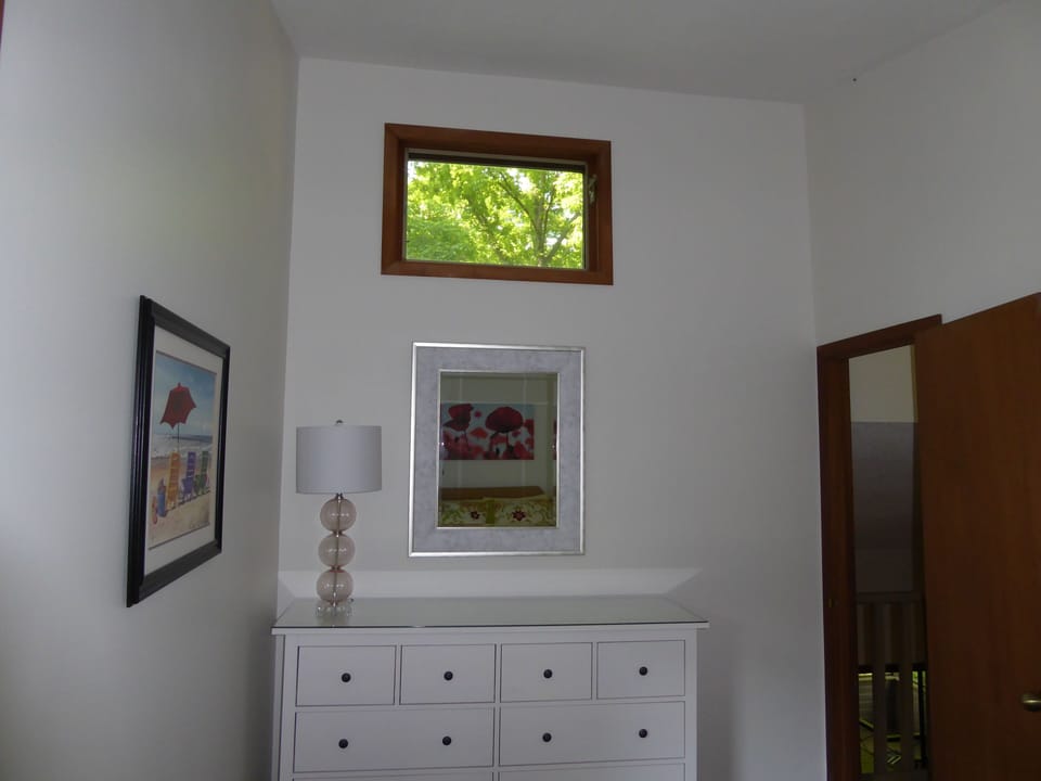 Bedroom 2, vaulted ceiling with tree top view
