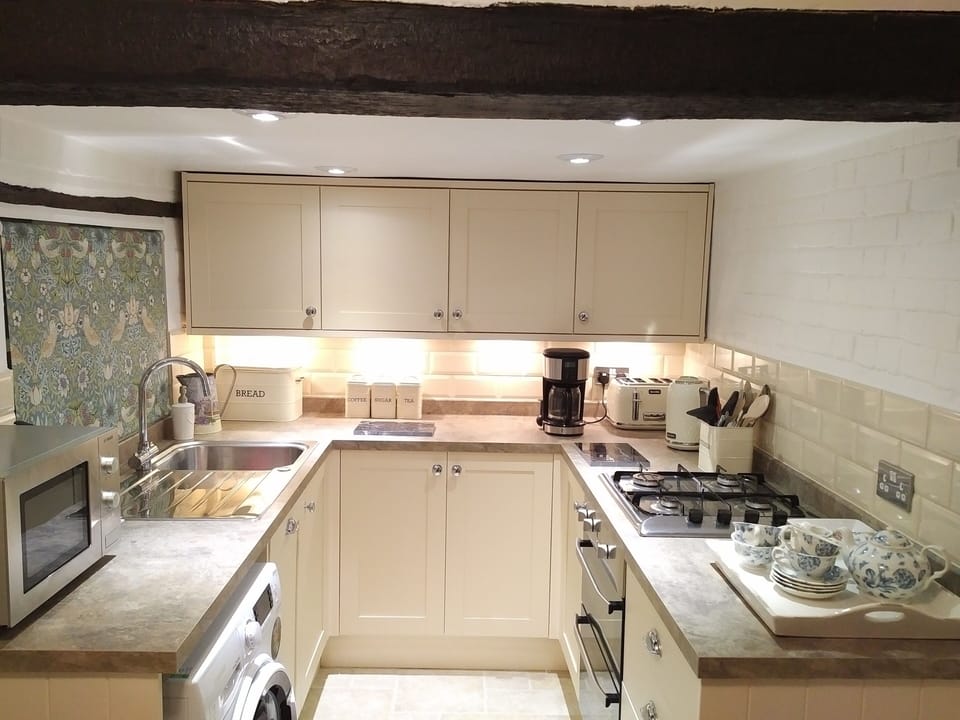 The kitchen which has a dishwasher and washing machine. 