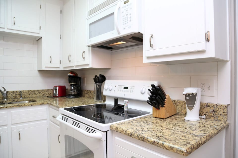 Fully equipped kitchen with granite counters and lots of cabinet space.