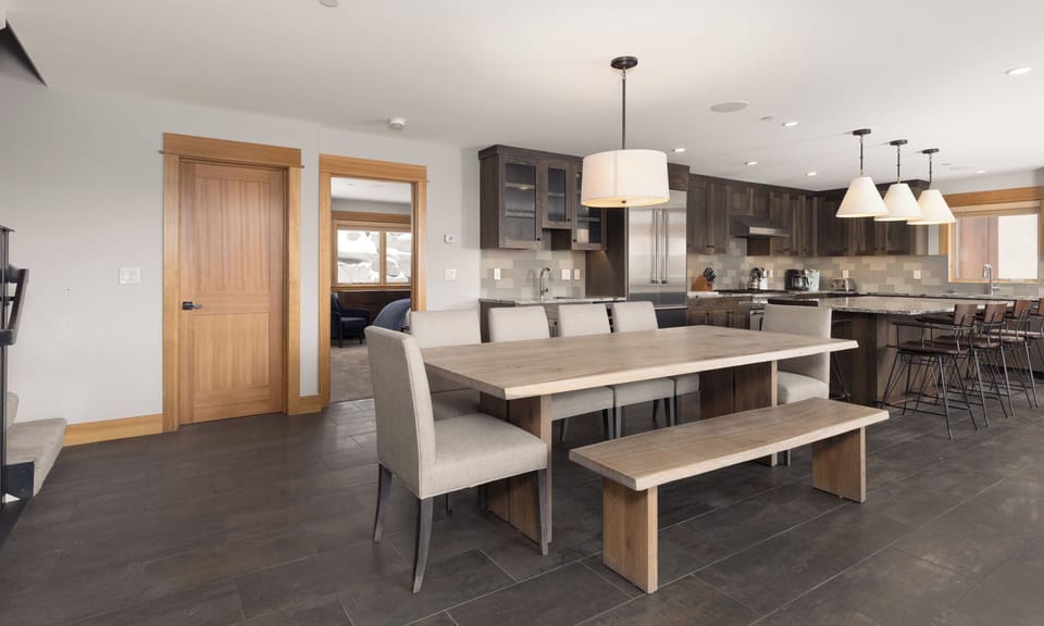 Your open-plan dining and kitchen space features warm wood tones, sleek countertops, and modern pendant lighting for memorable meals together.