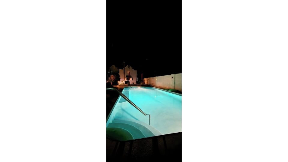 shared (8 homes) communal pool at night