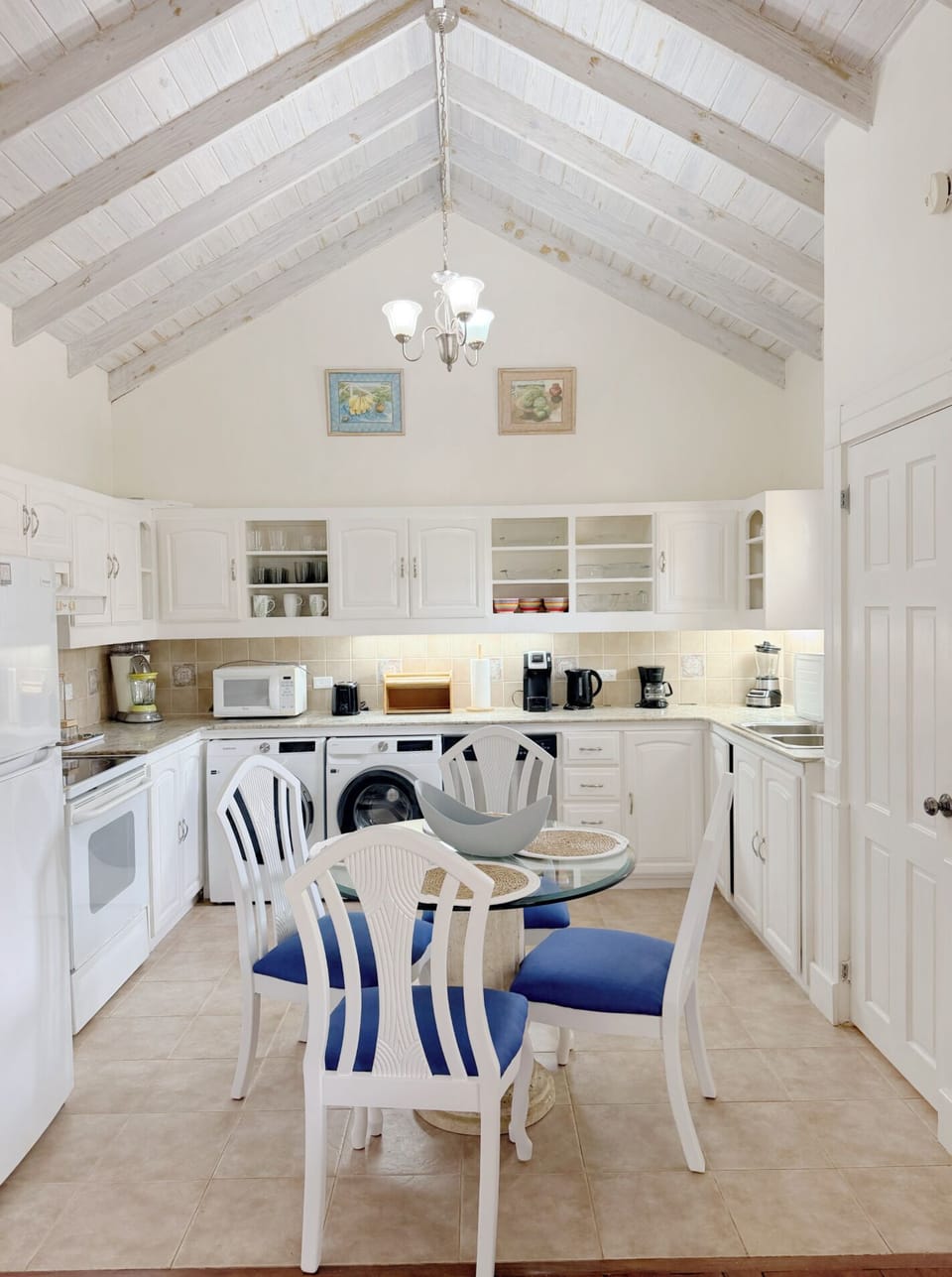 microwave, kitchen visible, indoor, coffee and or coffee maker, kitchen, oven, refrigerator, laundry, stovetop, dining table