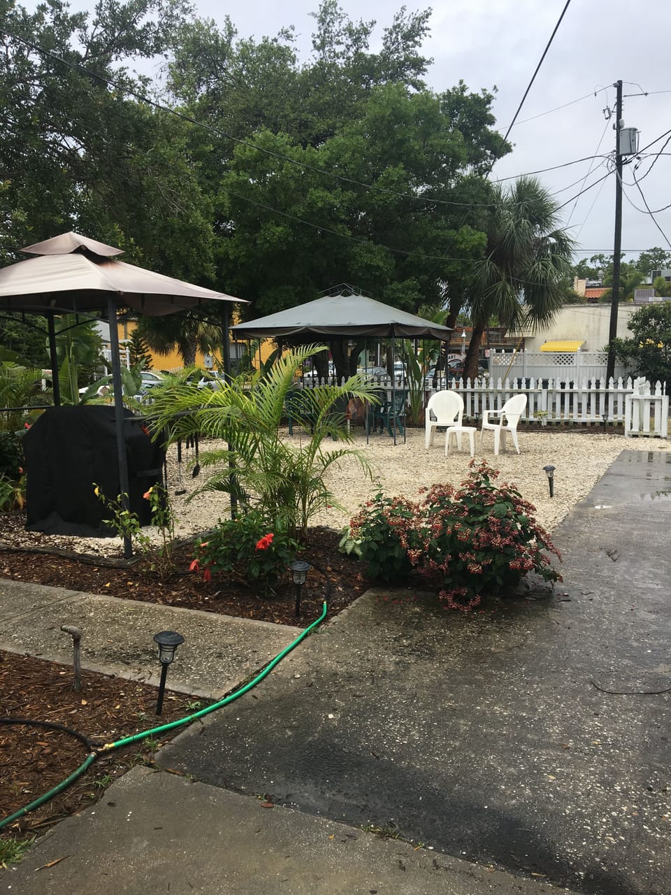 The shared garden area with barbecue, gazebo, table and chairs