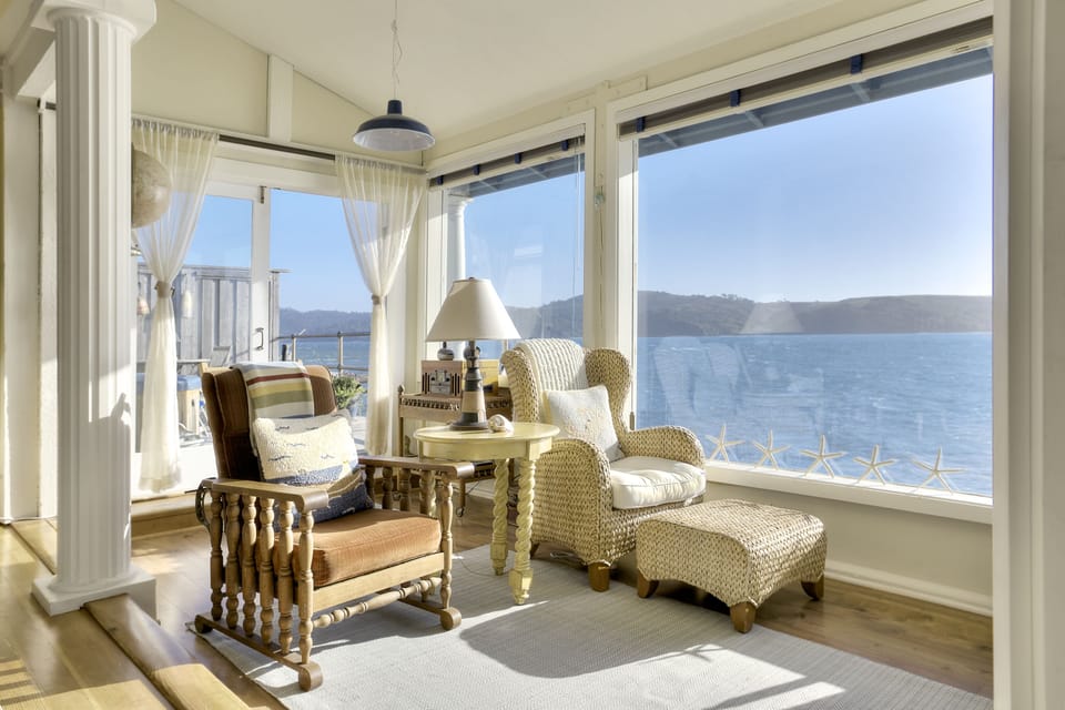 French doors open to private bayfront deck with hot tub and lounge chairs