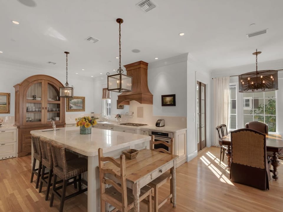 Kitchen and dining area, doors lead to balcony with grill.