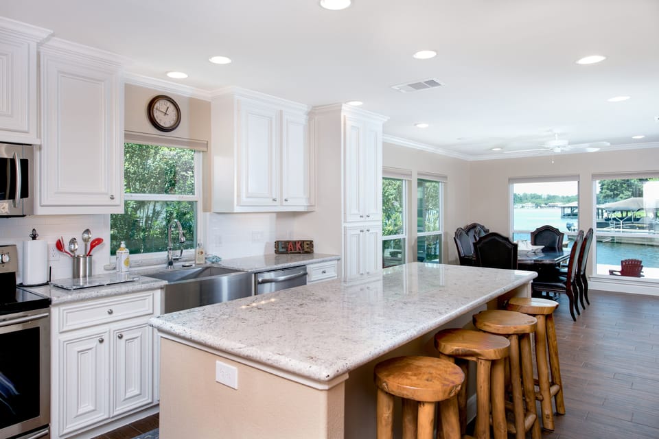 Island has built-in icemaker and wine cooler and half bath just off kitchen