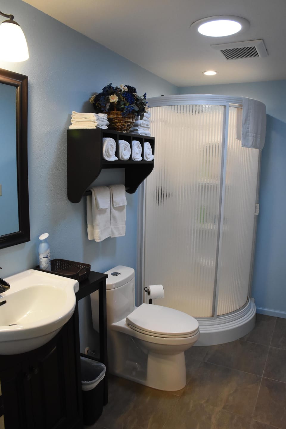 Bathroom with heated tile floor accessed from living or bedroom. Six bath towels