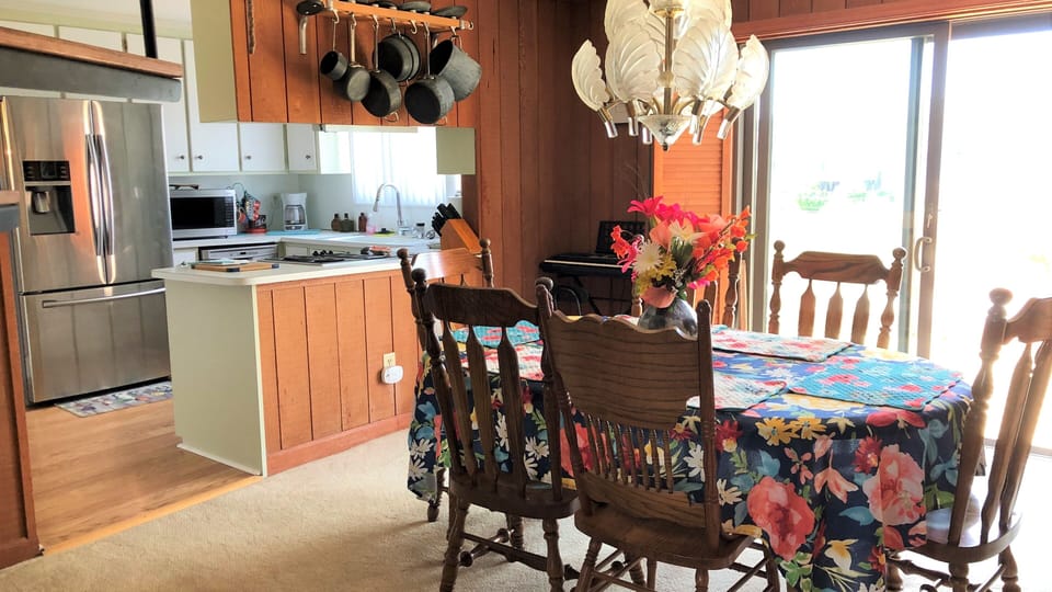 Dining room with beautiful shell light. table w/leaf,6 chairs, & high chair.