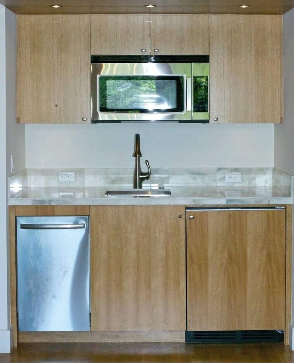 Kitchenette with quiet dishwasher, fridge and microwave.  Nespresso and Sodastream machines not shown