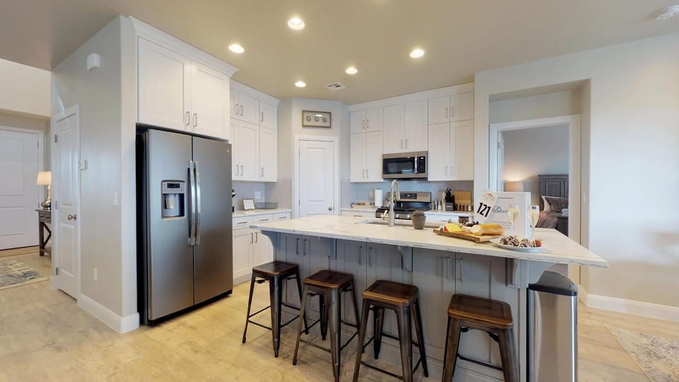 Fully stocked gourmet kitchen with extra seating at the bar