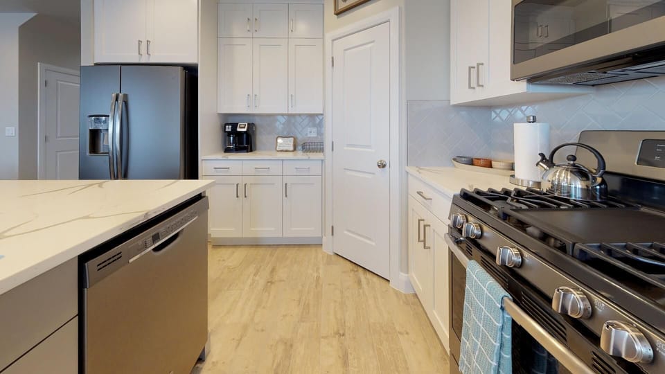 Fully stocked gourmet kitchen with top of the line stainless steel appliances