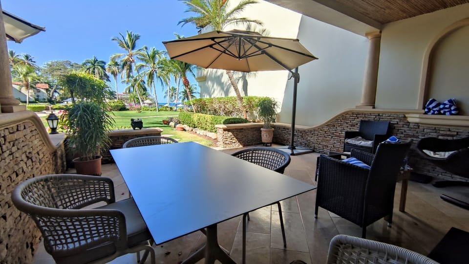 Outdoor dining table for 4, two easy chairs and a swing chair.