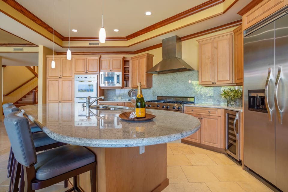 Welcome moments begin here, with rich wood details leading to the main living areas and upstairs suites.