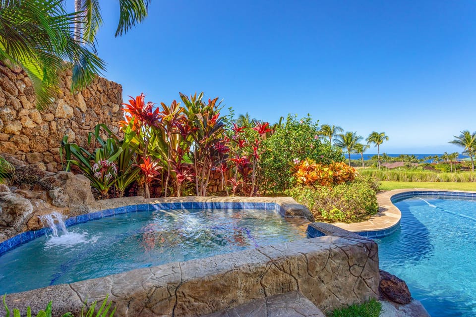 Unwind in the bubbling spa surrounded by tropical gardens and vibrant blooms.