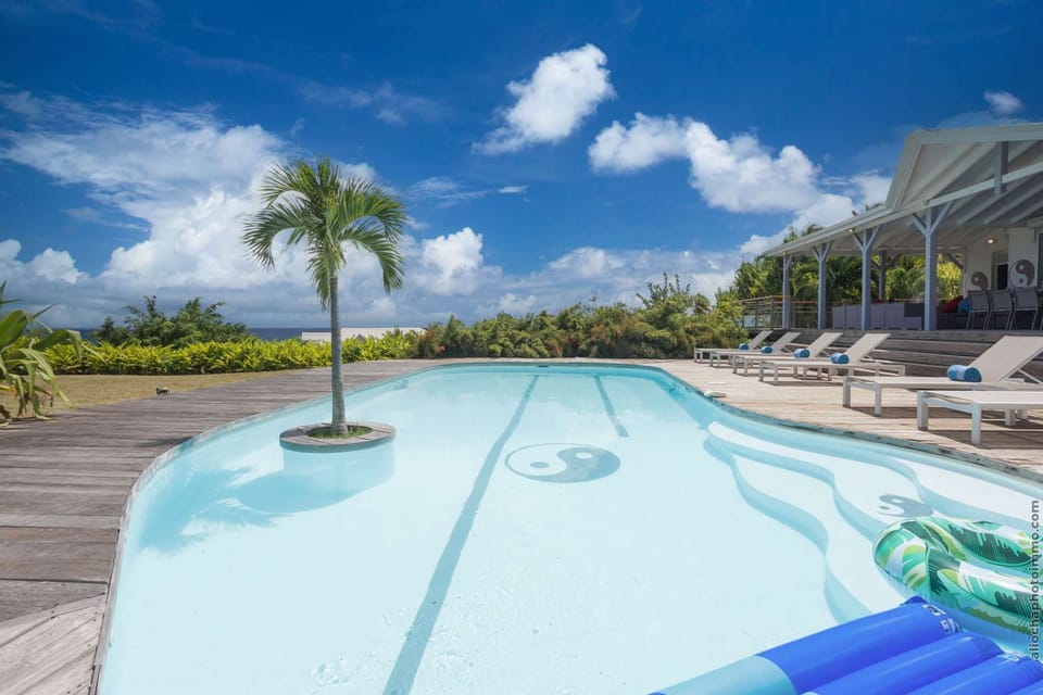 pool lounge chairs sea view yin yang villa rental ste anne Guadeloupe