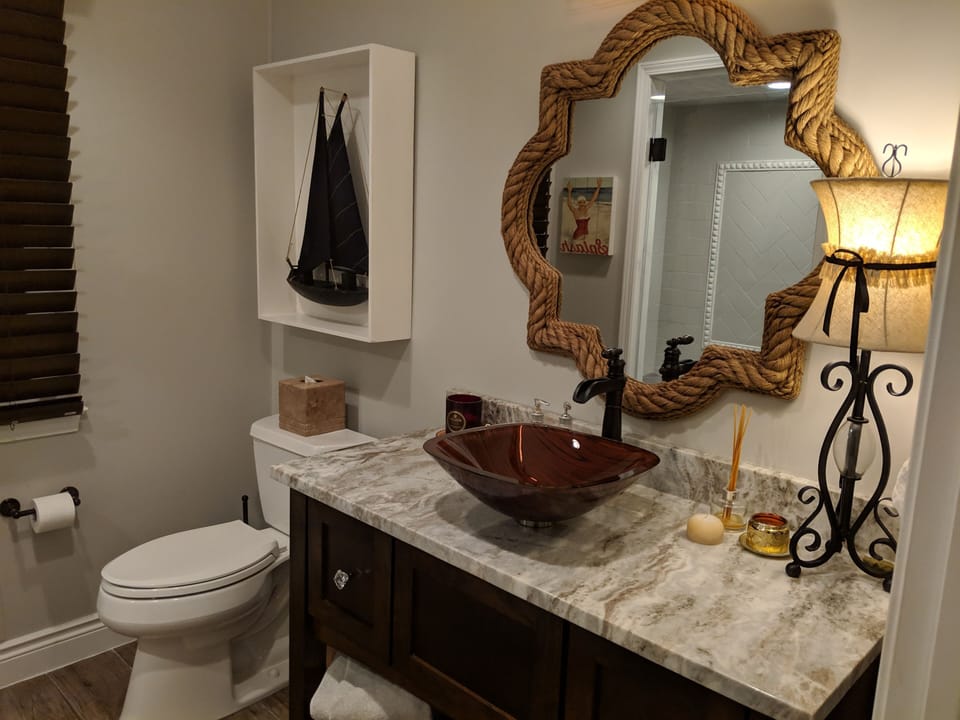 Granite counter, glass sink, ADA toilet